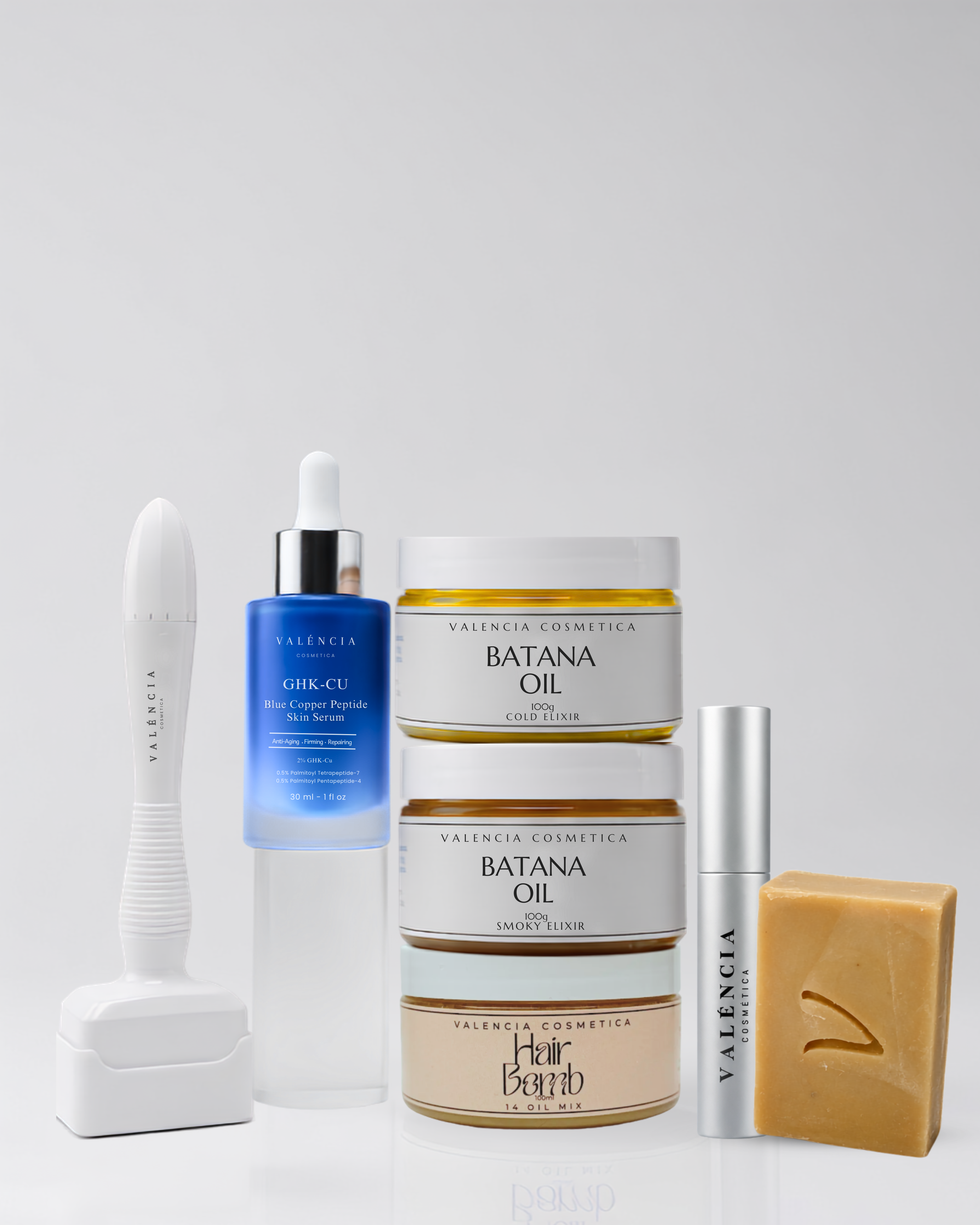 Skincare kit set with serum bottle, Batana oil jar, soap bar, and applicators