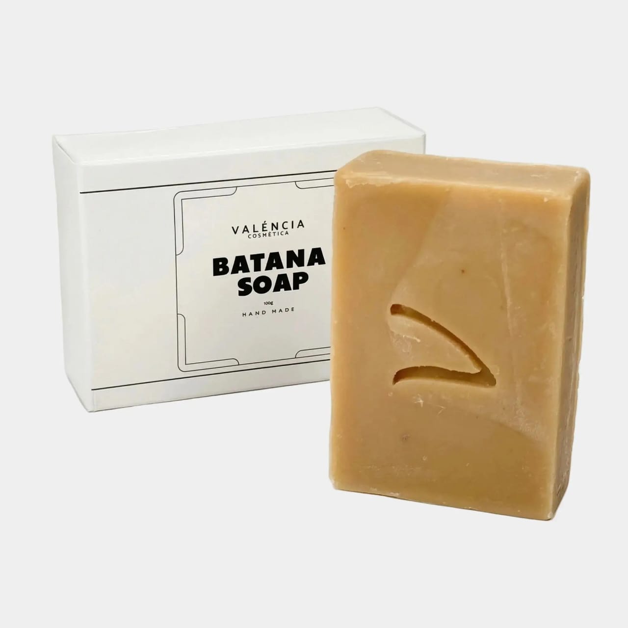 Batana soap bar with tan color and matching boxed packaging